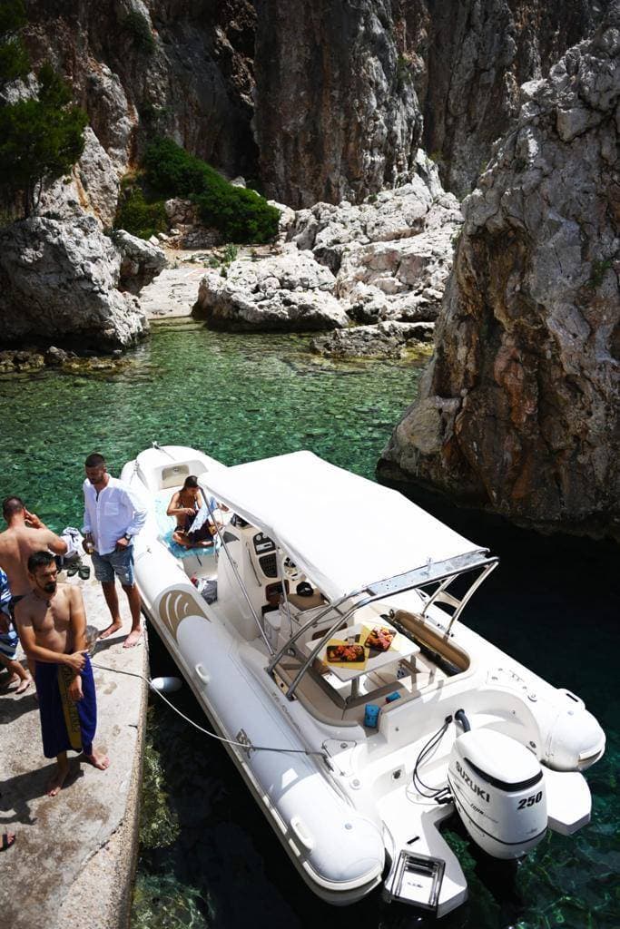 Private boat cruising through clear water around Hvar